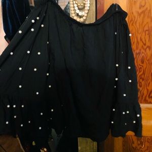 Black top, faux pearl details.